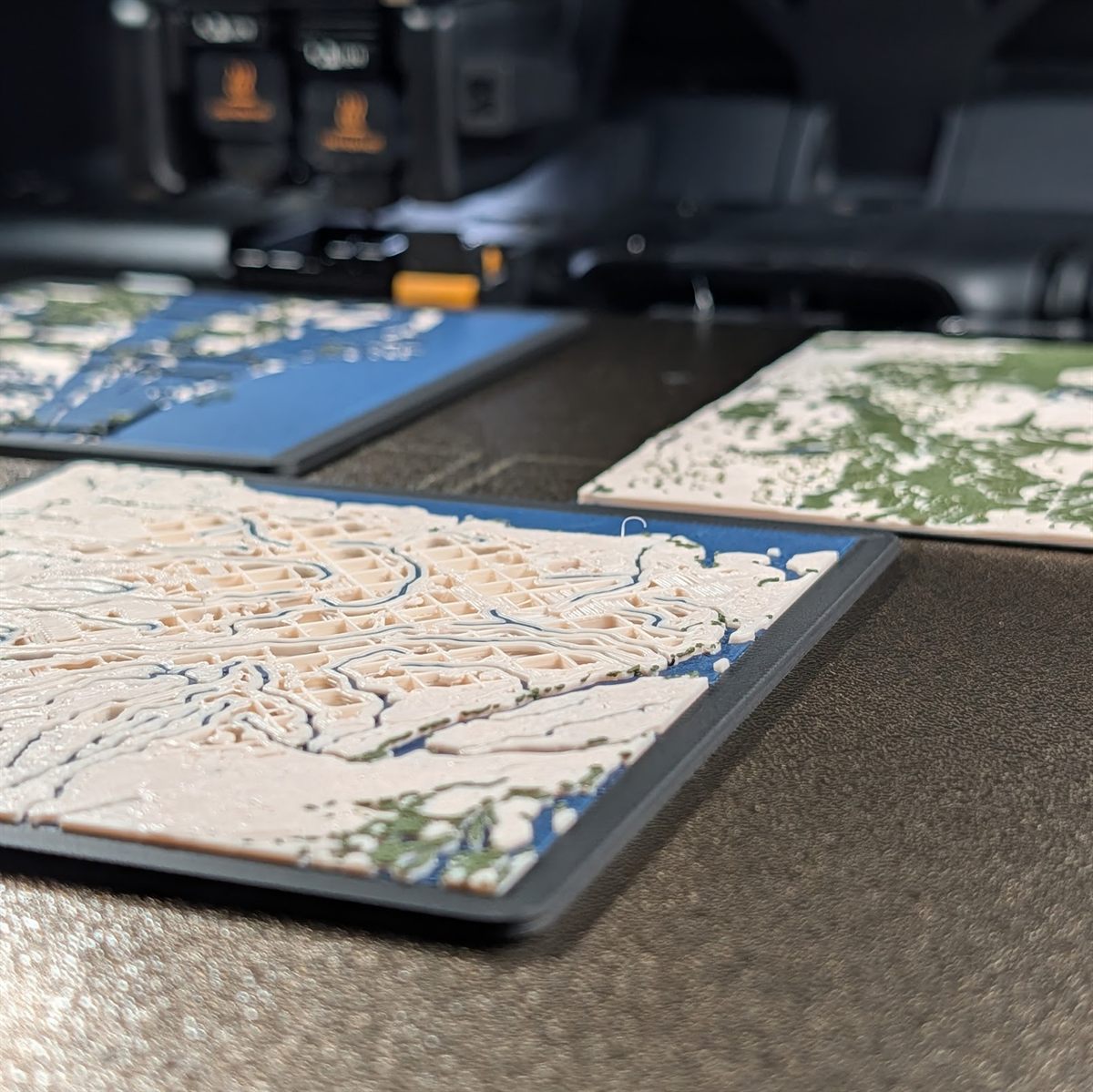 A spread of custom 3D map prints